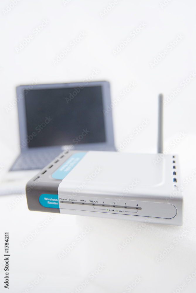 silver laptop and wireless router silver laptop and wireless router