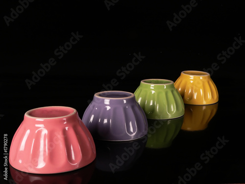 colored cups in a black background photo