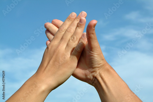 hands in hands against sky, gesture of friendship concept