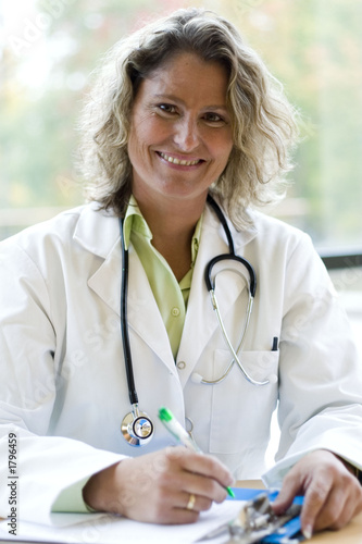 female medical professional writing