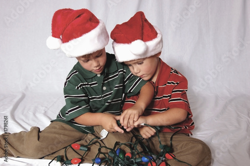 boys playing with christmas lights