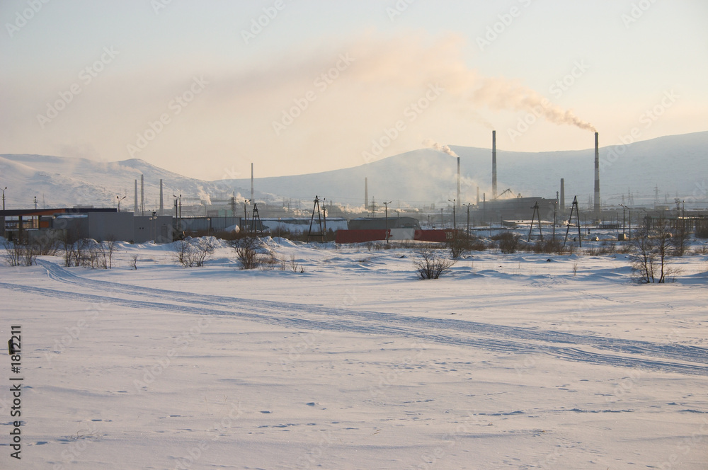 industrial snowy landscape with mountain background