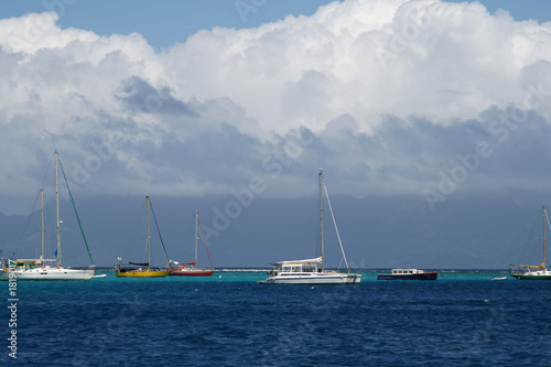 boats under tropical clouds