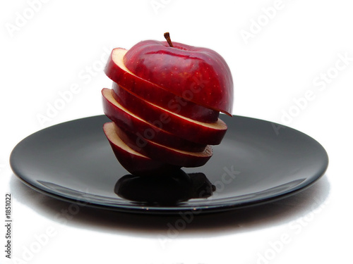 sliced apple on black plate too