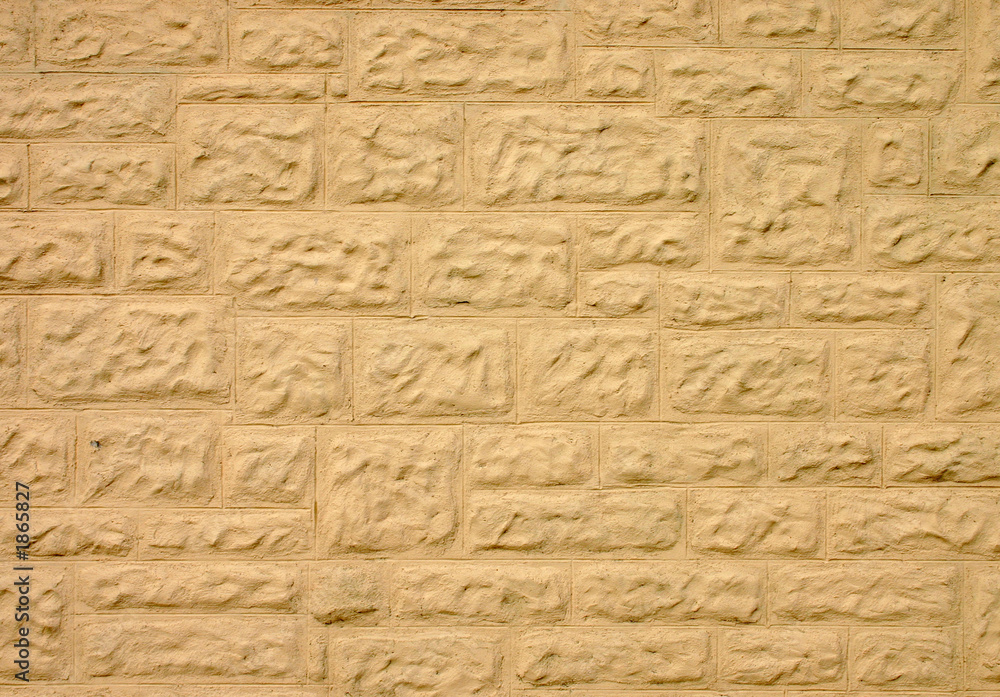 stone wall covered in cream colored coating