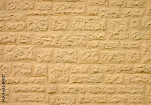stone wall covered in cream colored coating
