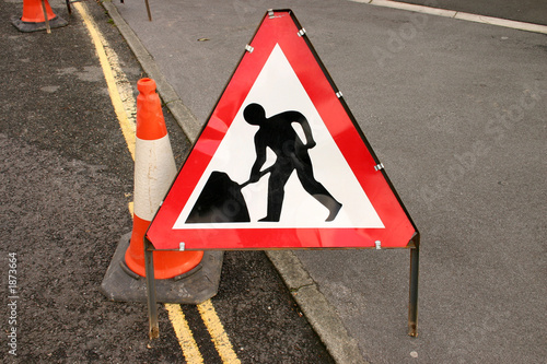 british roadwork’s sign and red cone on the side o photo