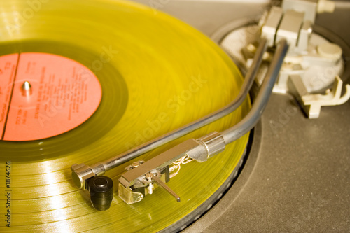 recordplayer with yellow lp records (33 1/3 rpm)