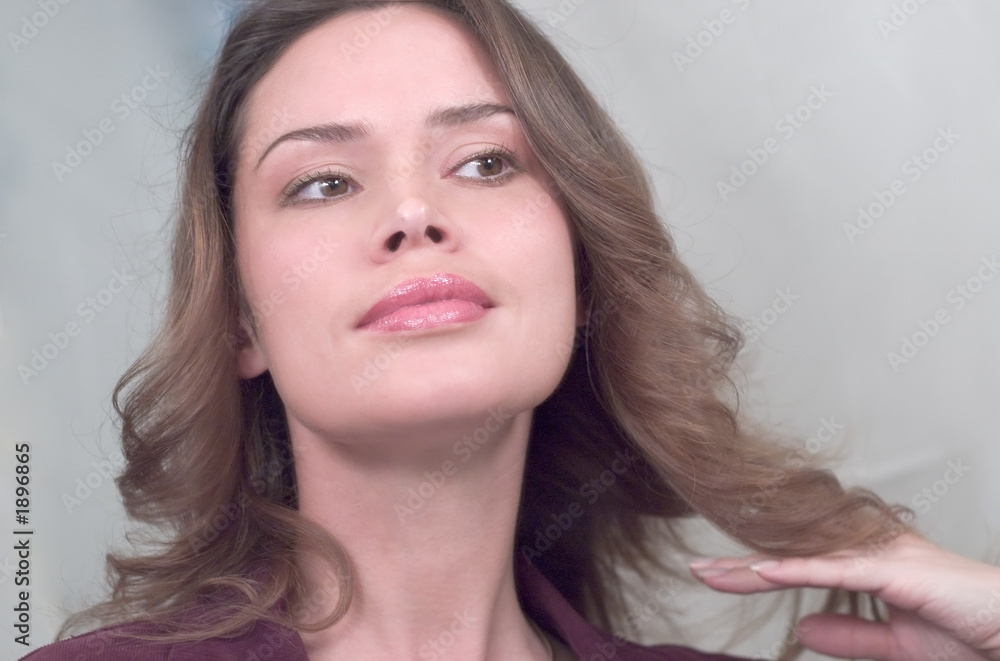 brunette is posign in front of mirror brunette is posign in front of mirror