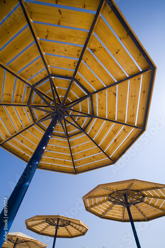parasols on a blue summer sky.