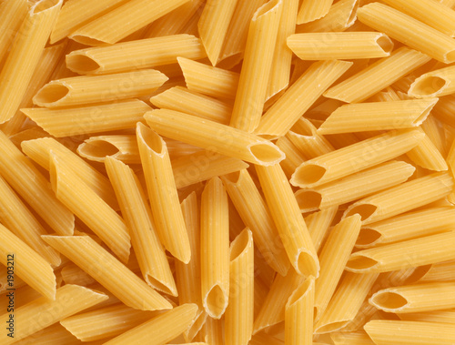 a background of fresh uncooked penne pasta