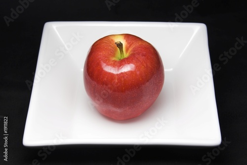 red apple on white plate