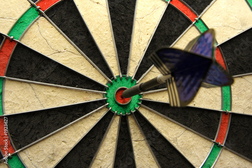 success shot! darts photo with arrow in bullseye photo