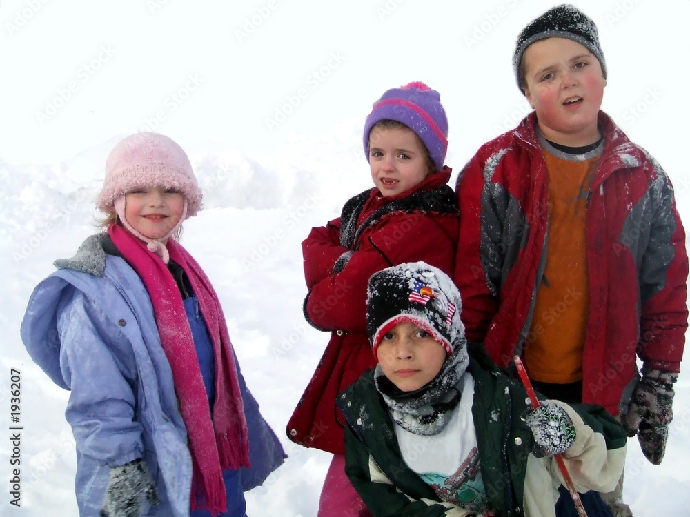 four kids playing in the snow