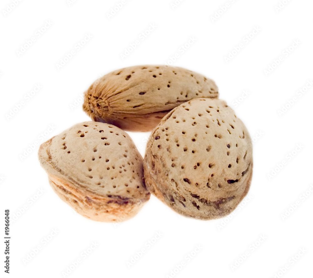 three almond nuts in a shell. three almond nuts in a shell.