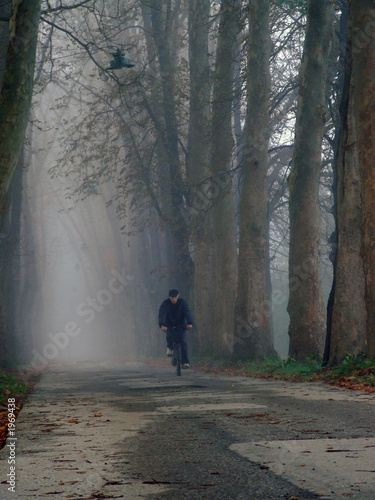 old man cycling at alley