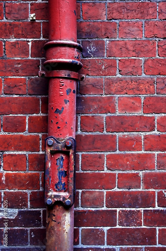 red water pipe and red brick wall © Anson Tsui 