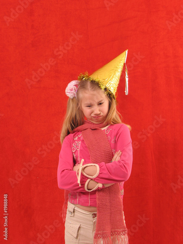 upset girl in birthday cap