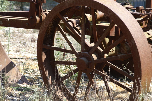 фотографія old wheel  - a part of rust plow