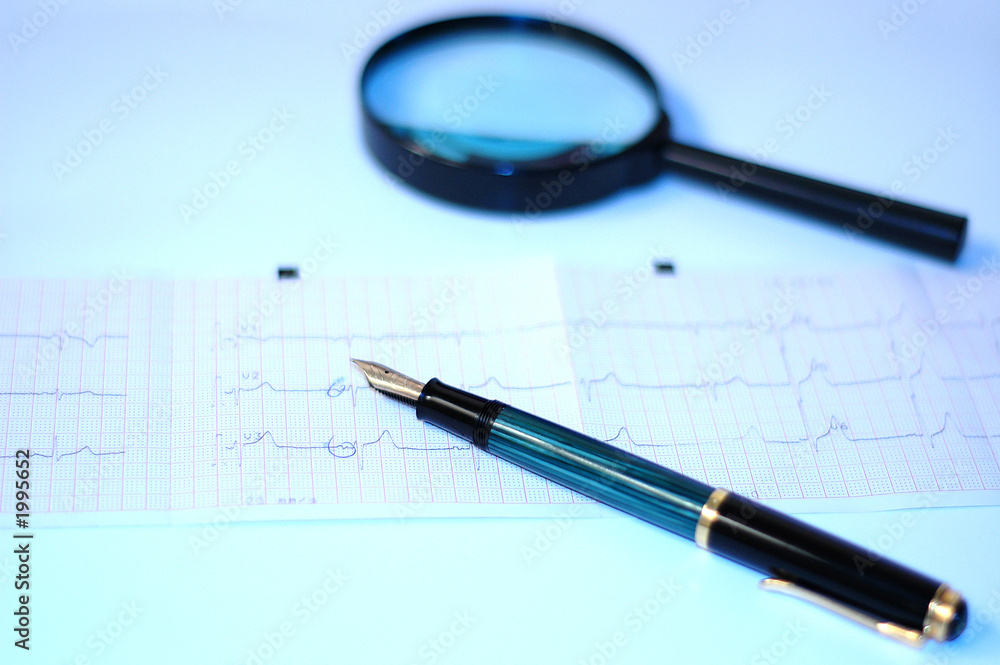 cardiogram, pencil and magnifying glass cardiogram, pencil and magnifying glass
