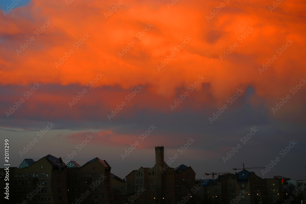 office buildings against a warm orange sky