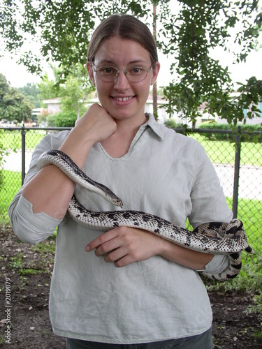 young woman holding a pine snake
