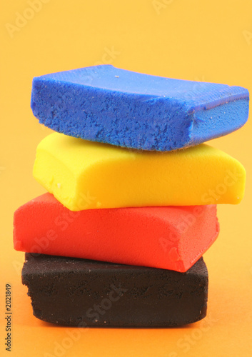 pile of colorful plasticine blocks on orange photo