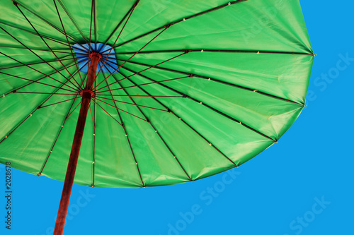 bright green umbrella against a blue sky
