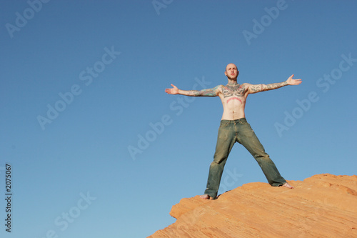 man on top of red rocks