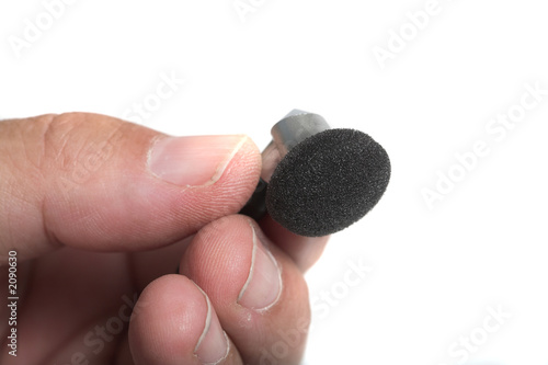 hand holding ear bud