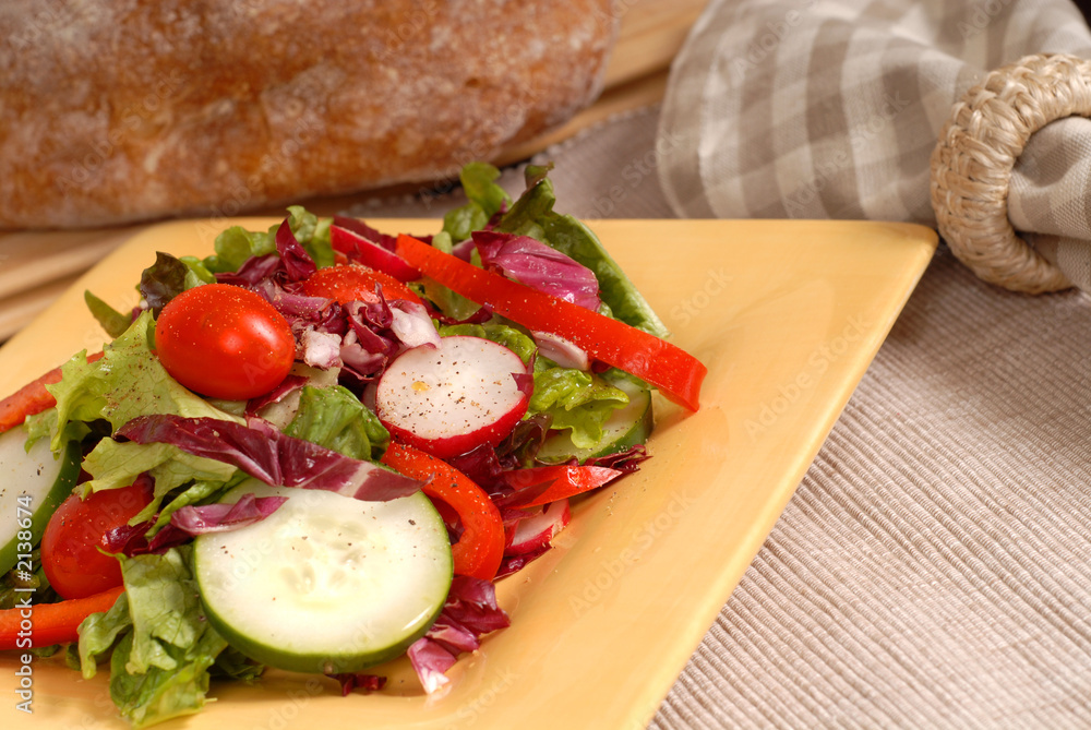crisp salad on a yellow plate with rustic bread crisp salad on a yellow plate with rustic bread