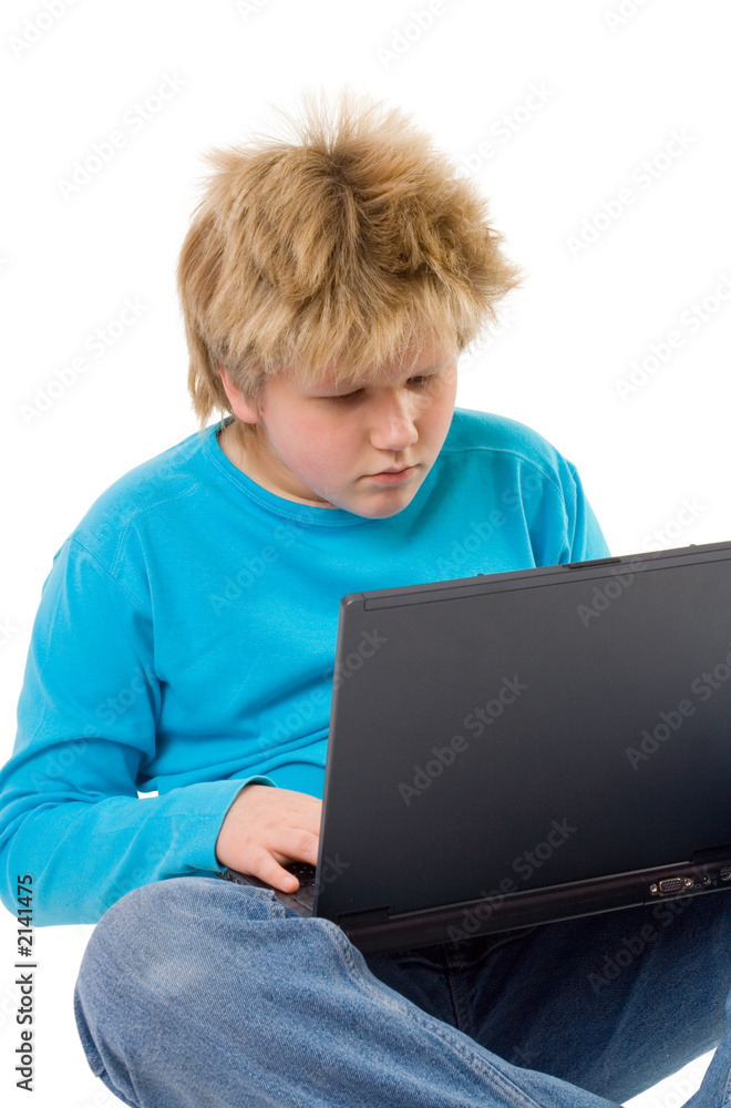 blonde boy working with laptop