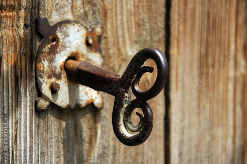 old house key in wooden doors.