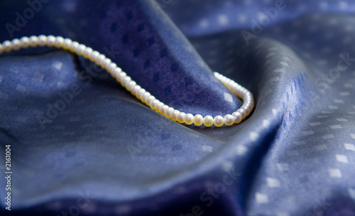 pearl necklace on dark blue silk