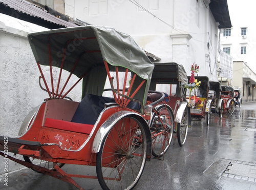 trishaws waiting in the rain