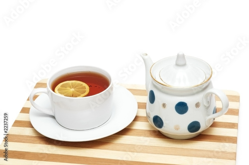 cup of tea with lemon and pot isolated on the whit