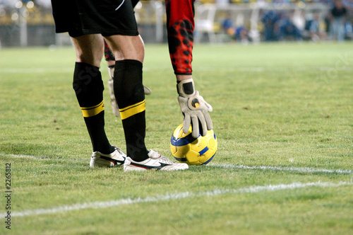the football goalkeeper puts a ball