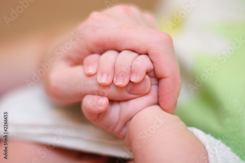 baby hold mother finger on your hand