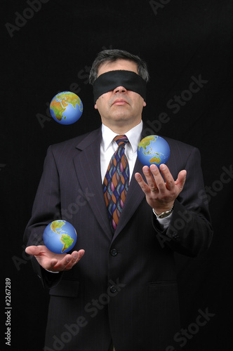 businessman juggling with planet earth photo