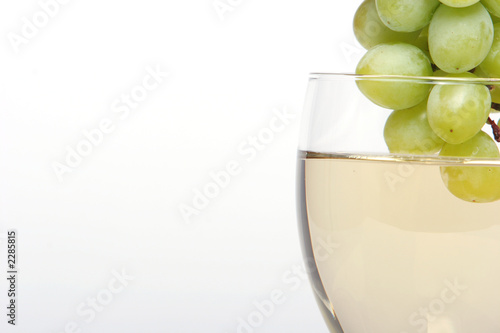 dipping white grapes into white wine