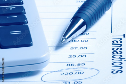 calculator and pen on financial statement photo