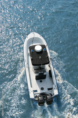 motorboat racing across water, overhead view