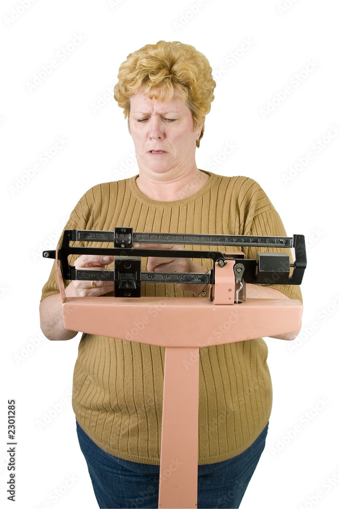 woman checking her weight on scale with path woman checking her weight on scale with path