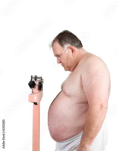 Overweight man weighing himself on scale