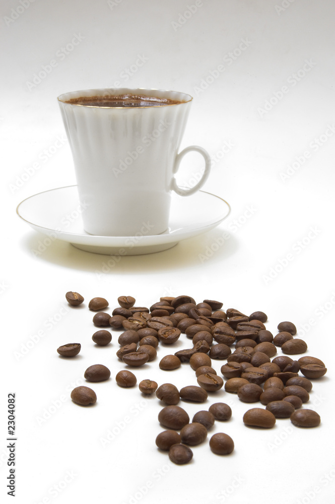 Naklejka premium white cup of espresso with coffee beans