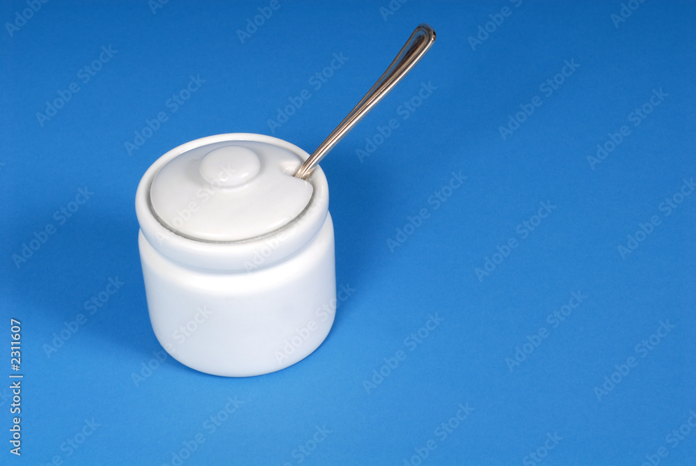 white sugar bowl on a blue background white sugar bowl on a blue background