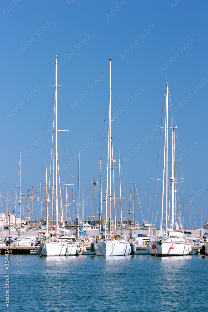 three tall sailing ships moored in sunny spanish p