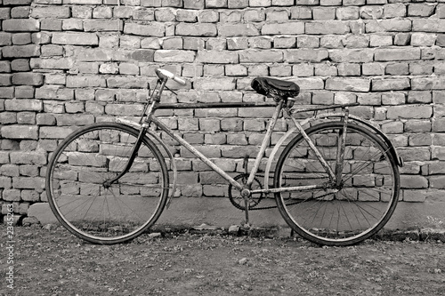 old bicycle leaning against a wall #2345263