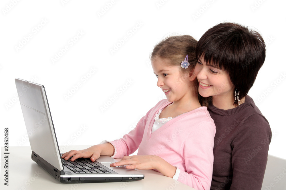 mother and daughter using laptop
