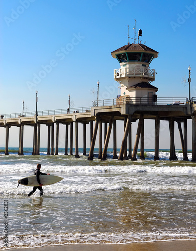 surfer by pier
